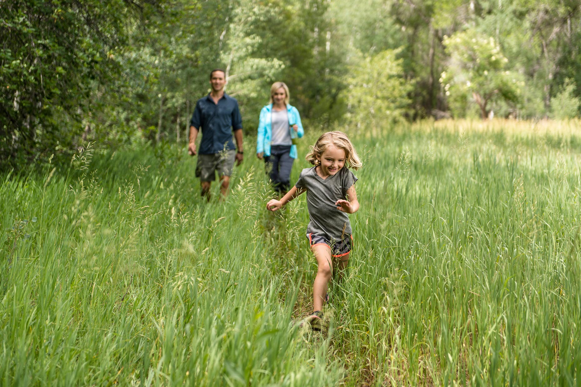 Active Lifestyle Photography - Girl runs through grass